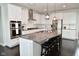 Spacious kitchen boasts stainless appliances, white cabinets, and large island with barstool seating at 4415 Voyageur Way, Carmel, IN 46074