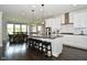 Bright kitchen with white cabinets, granite countertops, and a large island with bar seating at 4415 Voyageur Way, Carmel, IN 46074