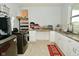 Well-equipped laundry room with washer, dryer, folding table, storage and tiled floors at 4415 Voyageur Way, Carmel, IN 46074