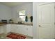 Convenient laundry room with white cabinets, sink, and tiled backsplash at 4415 Voyageur Way, Carmel, IN 46074