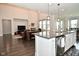 Open concept living space, combining the kitchen island with the living room fireplace at 4415 Voyageur Way, Carmel, IN 46074