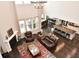 Open concept living room with fireplace, hardwood floors, and view of kitchen island at 4415 Voyageur Way, Carmel, IN 46074