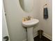 Stylish powder room with pedestal sink, round mirror, and modern fixtures at 4415 Voyageur Way, Carmel, IN 46074