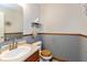 Neat half bathroom featuring fresh paint, modern fixtures, and wood grain accents at 464 Hummingbird Ln, Whiteland, IN 46184