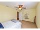 This bedroom features tan walls, a ceiling fan, and carpet throughout at 464 Hummingbird Ln, Whiteland, IN 46184
