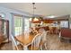 Open dining area and view of a kitchen with wood floors and natural light at 464 Hummingbird Ln, Whiteland, IN 46184