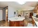 Open floor plan of kitchen that provides access to the dining area and half bathroom at 464 Hummingbird Ln, Whiteland, IN 46184
