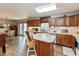 This kitchen features wood cabinets, barstool seating, hardwood floors, and stainless-steel appliances at 464 Hummingbird Ln, Whiteland, IN 46184