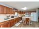 Bright kitchen features wooden cabinets, stainless steel appliances, and a cozy breakfast bar at 464 Hummingbird Ln, Whiteland, IN 46184