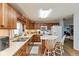 Bright kitchen features wooden cabinets, stainless steel appliances, and a cozy breakfast bar at 464 Hummingbird Ln, Whiteland, IN 46184