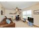 Living room featuring carpet, a sofa, ceiling fan, and a large window for natural light at 464 Hummingbird Ln, Whiteland, IN 46184