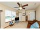 Living room featuring carpet, a sofa, ceiling fan, and a large window for natural light at 464 Hummingbird Ln, Whiteland, IN 46184