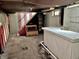Unfinished basement with exposed ceiling, a partially built bar, and vintage decor, perfect for remodeling at 505 W 40Th St, Indianapolis, IN 46208