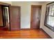 This bedroom has hardwood floors, wood trim, and neutral wall colors offering a blend of comfort and style at 505 W 40Th St, Indianapolis, IN 46208