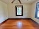 This bedroom features hardwood floors, bright natural light, and a ceiling fan providing a comfortable and inviting living space at 505 W 40Th St, Indianapolis, IN 46208