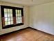 Cozy bedroom featuring hardwood floors, light walls, and a bright window with pink shutters at 505 W 40Th St, Indianapolis, IN 46208