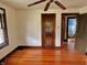 Bright bedroom featuring hardwood floors, ceiling fan, and doorway to an adjoined bathroom with claw foot tub at 505 W 40Th St, Indianapolis, IN 46208
