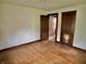 Bright bedroom featuring hardwood floors, light walls, and a view of an adjacent room at 505 W 40Th St, Indianapolis, IN 46208