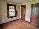 This bedroom has hardwood floors, wood trim, a window with open shutters and neutral wall colors creating a classic feel at 505 W 40Th St, Indianapolis, IN 46208