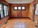 Dining room with hardwood floors, paneled walls, ceiling lighting, and a window for natural light at 505 W 40Th St, Indianapolis, IN 46208