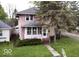 Charming two-story home featuring a cozy screened front porch and mature landscaping in a residential area at 505 W 40Th St, Indianapolis, IN 46208