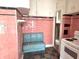 Close-up of a vintage kitchen featuring pink tile, a retro booth, and classic white appliances at 505 W 40Th St, Indianapolis, IN 46208