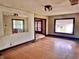Empty living room featuring hardwood floors, a mirror, and large windows, ready for personalization at 505 W 40Th St, Indianapolis, IN 46208