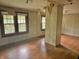 Spacious living room featuring hardwood floors, two windows, and wood paneling at 505 W 40Th St, Indianapolis, IN 46208