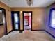 Open living room displaying doorways leading to the kitchen with unique red tiles and white appliances at 505 W 40Th St, Indianapolis, IN 46208