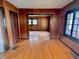 Living room with hardwood floors, wood paneled walls, and a doorway to an adjoined room at 505 W 40Th St, Indianapolis, IN 46208