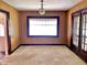 View of an empty living room with paneled walls and a vintage chandelier, awaiting updates at 505 W 40Th St, Indianapolis, IN 46208