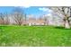 Expansive backyard showcasing the home's setting amidst mature trees and green lawn at 5196 N London Rd, Fairland, IN 46126