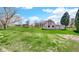 Charming barn with white exterior and red trim surrounded by a lush green field, offering rustic charm at 5196 N London Rd, Fairland, IN 46126