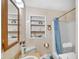 Neutral toned bathroom with a shower and built-in shelves, providing functionality and storage at 5196 N London Rd, Fairland, IN 46126