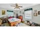 Bedroom with ceiling fan, ample natural light, and unique decor, offering a personalized and inviting space at 5196 N London Rd, Fairland, IN 46126
