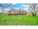 Quaint single story house with stone accents and a covered porch surrounded by a sprawling green lawn at 5196 N London Rd, Fairland, IN 46126