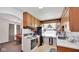 Efficient kitchen with wooden cabinetry, white appliances, and ample counter space at 5196 N London Rd, Fairland, IN 46126