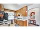 Functional kitchen with wooden cabinets, white countertops, and modern appliances at 5196 N London Rd, Fairland, IN 46126