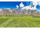 Large backyard with lush green grass and mature trees at 5397 Ripplingbrook Way, Carmel, IN 46033