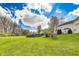 A well-maintained backyard with lush green grass and trees at 5397 Ripplingbrook Way, Carmel, IN 46033