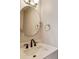 Modern bathroom with updated fixtures, vanity and circular mirror create a stylish retreat at 5397 Ripplingbrook Way, Carmel, IN 46033