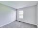 Carpeted bedroom offers a window, neutral paint, and closet at 5397 Ripplingbrook Way, Carmel, IN 46033
