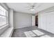 Neutral bedroom featuring carpet, a ceiling fan, a window, and a closet at 5397 Ripplingbrook Way, Carmel, IN 46033