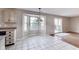 Cozy dining area with white tile flooring, bright bay window, and Tiffany style pendant lighting at 5397 Ripplingbrook Way, Carmel, IN 46033