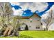 An exterior view of a home with mature trees, lush lawn and wood deck at 5397 Ripplingbrook Way, Carmel, IN 46033