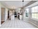 Bright eat-in kitchen features tile floors, modern lighting and an island for extra counter space at 5397 Ripplingbrook Way, Carmel, IN 46033
