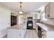 Charming kitchen with an island, black appliances, and tile flooring at 5397 Ripplingbrook Way, Carmel, IN 46033