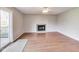 Living room with hardwood flooring, a fireplace, and sliding glass doors to a deck at 5397 Ripplingbrook Way, Carmel, IN 46033