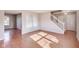 Spacious living room with hardwood floors, natural light, and a staircase leading upstairs at 5397 Ripplingbrook Way, Carmel, IN 46033