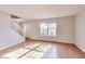 Bright and spacious living room featuring hardwood floors and natural light from a large window at 5397 Ripplingbrook Way, Carmel, IN 46033